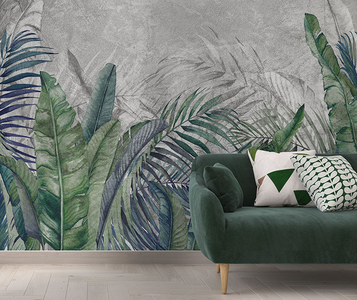 Tropikalne liście palmowe i bananowe na betonowej ścianie